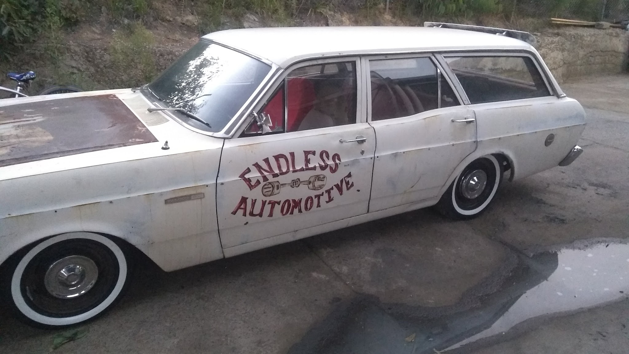 A vintage Ford Falcon wagon with Endless Automotive hand-painted on the door
